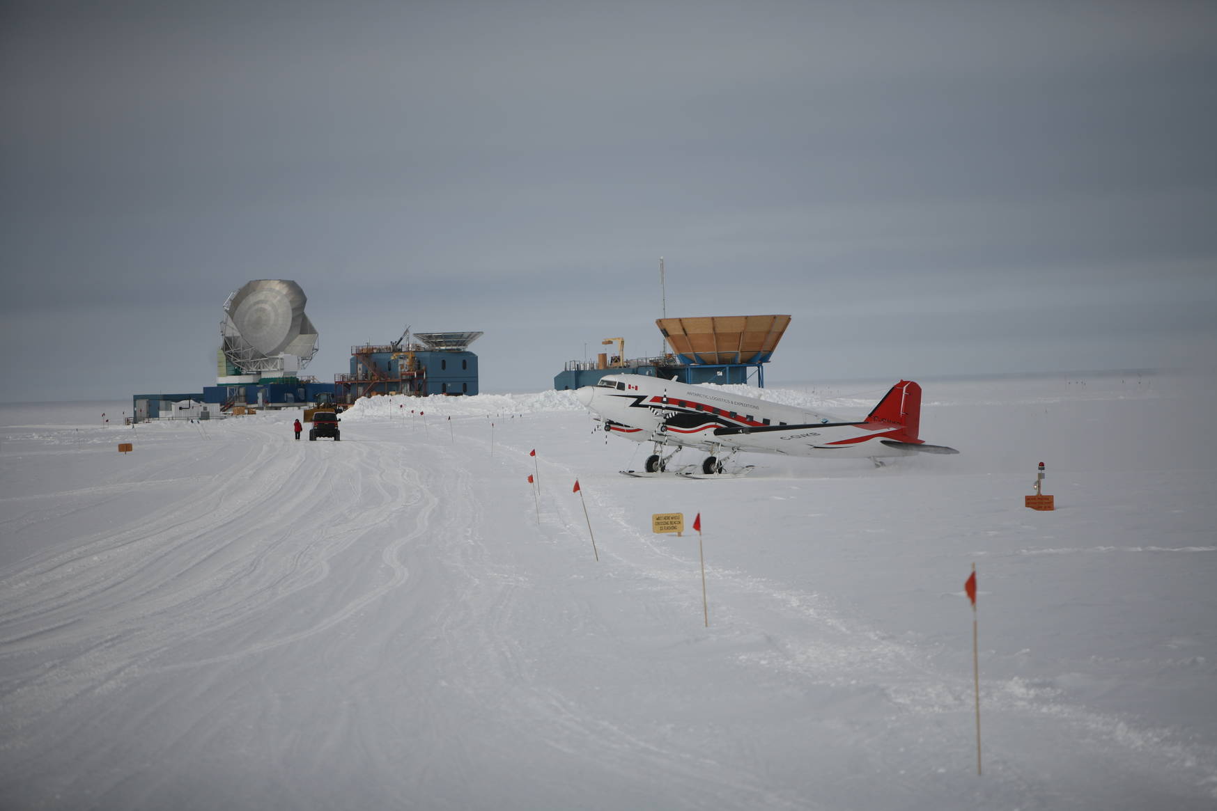A ski-equipped Basler aircraft picking up the crew of the tourist camp to take them to their next adventure. In the background: the South Pole Telescope (left), BICEPS-3 (middle), Keck (right).