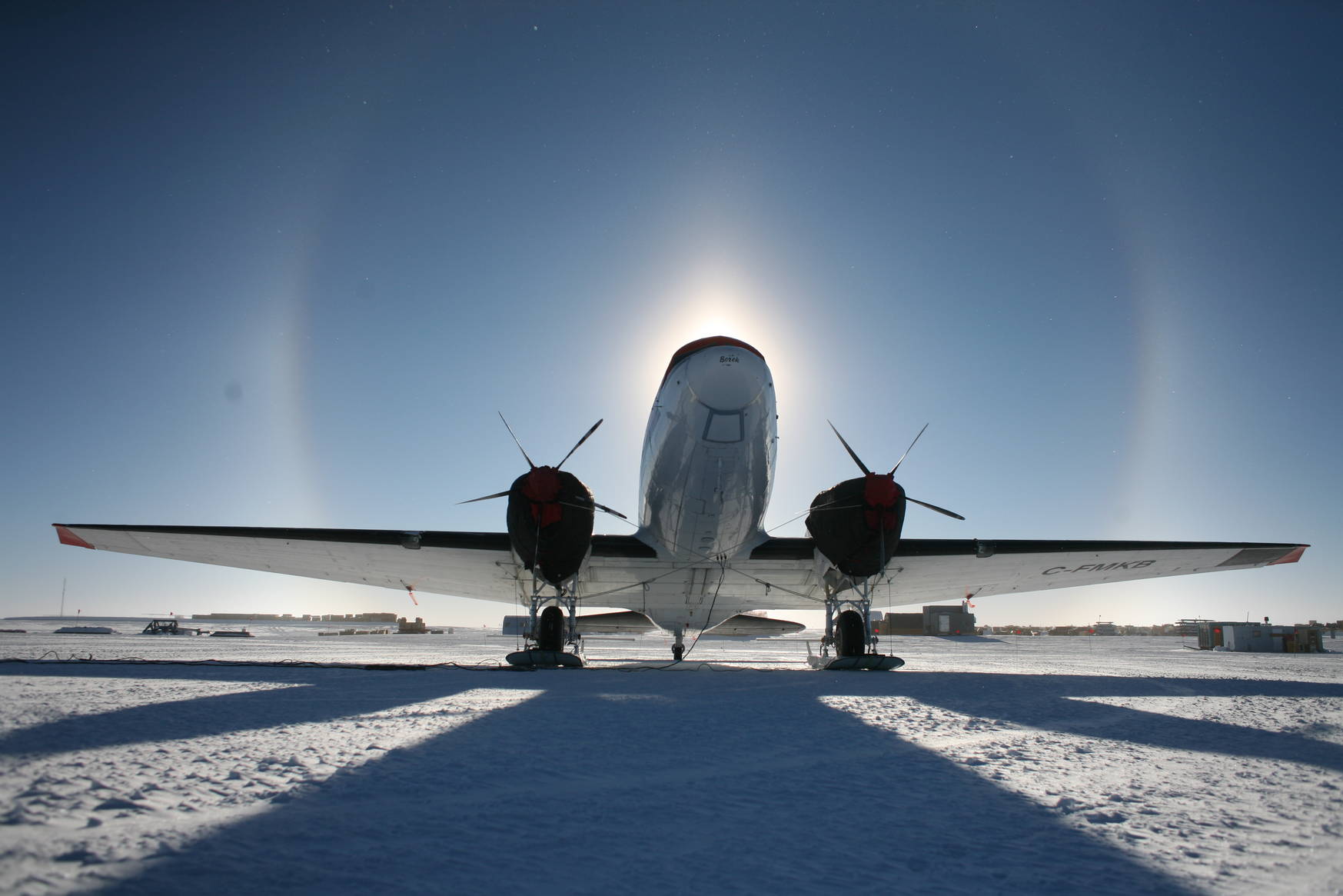 A Basler aircraft surrounded by a halo of the Sun.