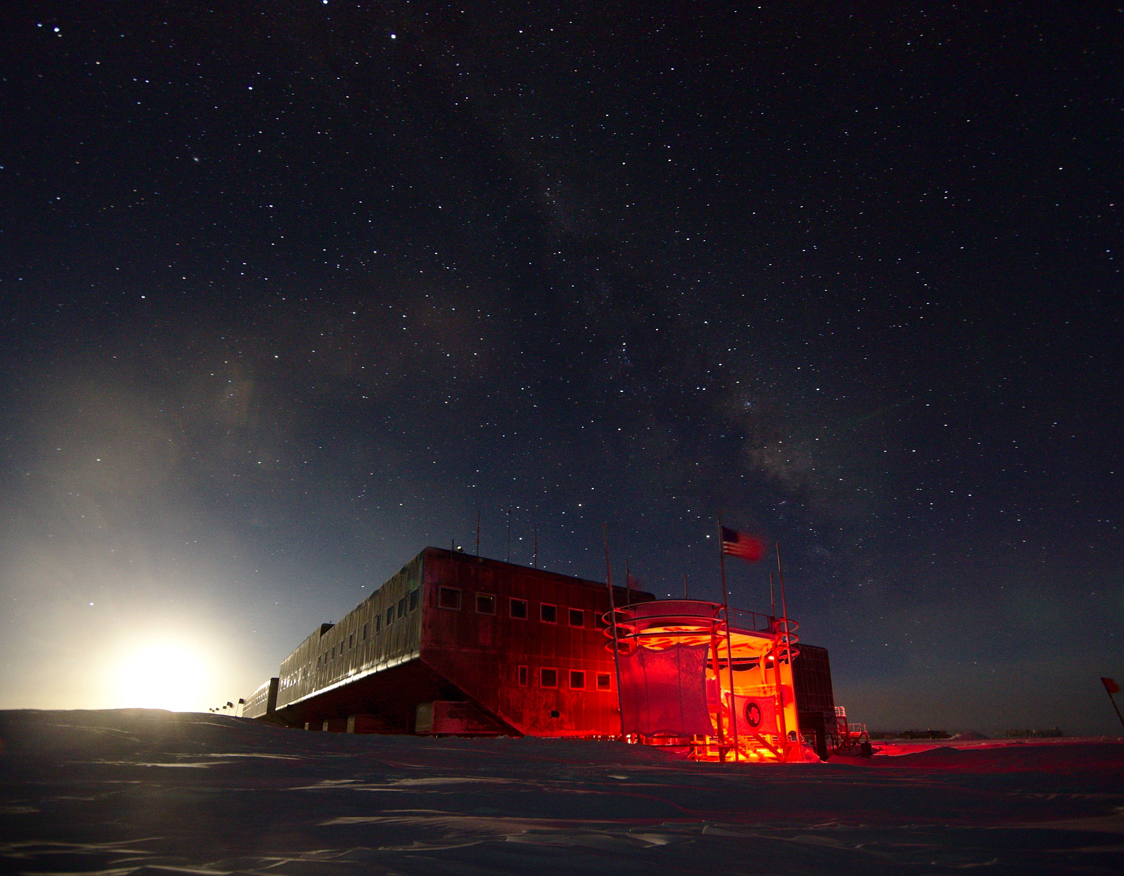 The entrance to the Amundsen-Scott research station. The bright light of the Moon illuminates the side of the station