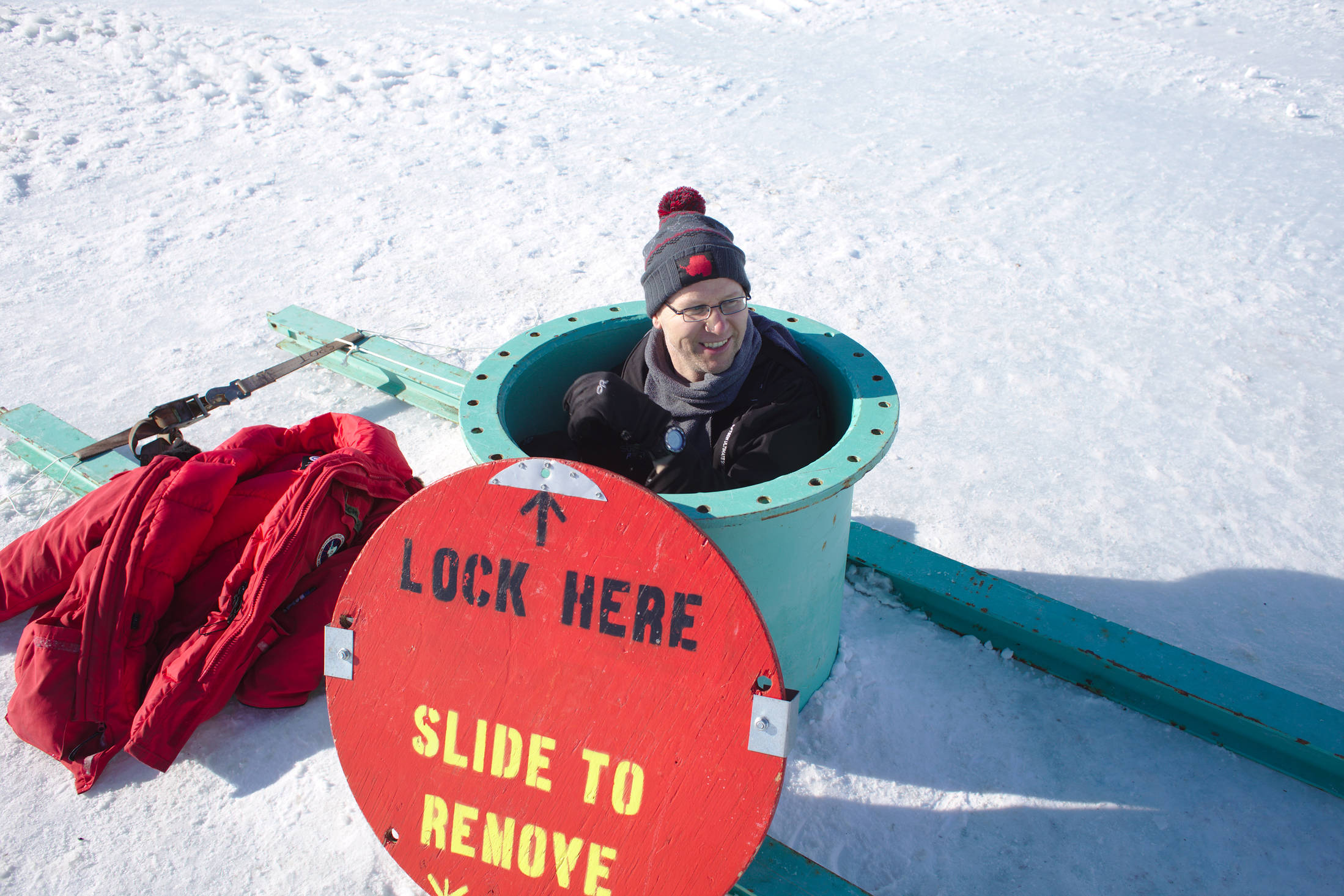 Entrance into the observation tube. After climbing down a ladder one can sit behind glass in a little tube compartment under the sea ice and watch the fish, seals, and divers